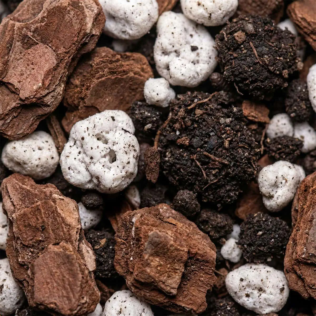 Chunky aroid potting mix for monstera plant care, showing ingredients.